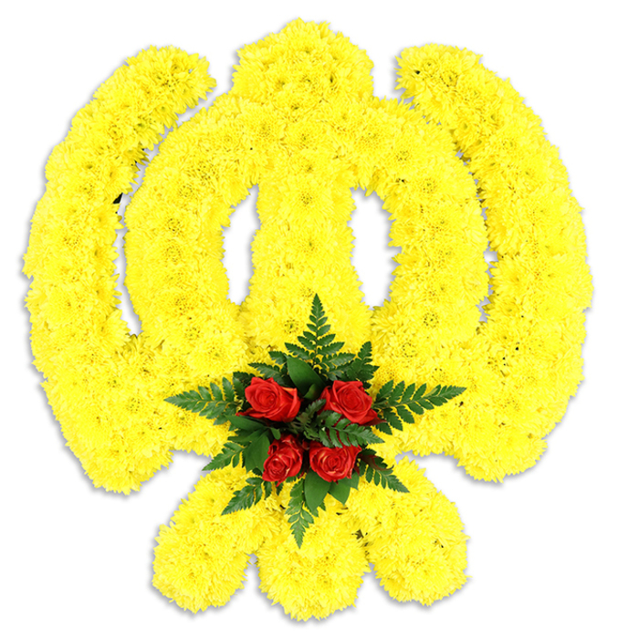 Dominating a clean white field, a hand-assembled Khanda emblem is composed from thousands of small, bright yellow chrysanthemum blooms, each arranged with deliberate care so the circular chakkar, the two outward-sweeping kirpans, and the central double-edged khanda read with clarity and depth. The chrysanthemums form a richly textured surface-soft to the eye, slightly pillowed-so the emblem feels almost sculptural. At the very heart of the Khanda, where lines cross and attention naturally gathers, a tight cluster of five deep red roses provides a striking counterpoint: their velvety petals and concentrated colour draw the eye inward and are hugged by dark green fern foliage that adds cool shading and botanical contrast. The white background makes the yellow sing and the red deepen, while a gentle grey shadow beneath the arrangement gives a sense of weight and presence, as though it had been set down on an easel for a memorial service. The scent would be understated-powdery chrysanthemums with the classic, fuller perfume of roses-and the overall mood balances reverence with calm brightness. Prepared by Bexley Flowers with local sensibility, this tribute suits ceremonial uses across Bexley, from small family gatherings in Bexley Village to larger commemorations near Crayford, offering a visual language of faith, respect, and careful craftsmanship.